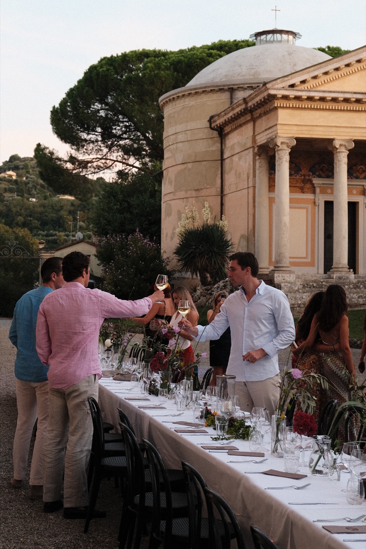A long table set for dinner outdoors
